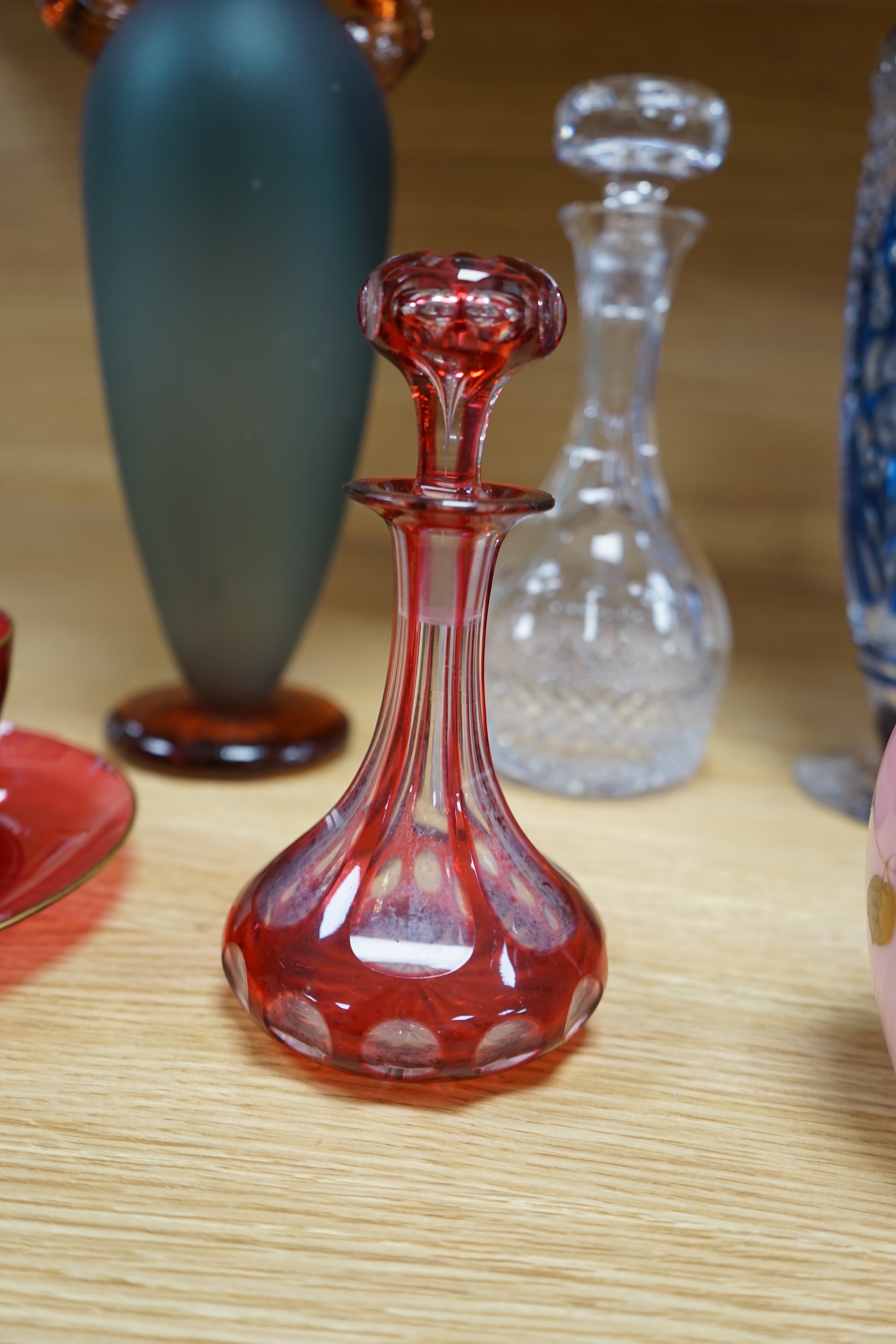 A collection of mixed 19th/20th century coloured glassware, to include a monogrammed cranberry bowl and plate, a flashed glass vase and a small opaque floral vase, largest 34cm high. Condition - fair to good